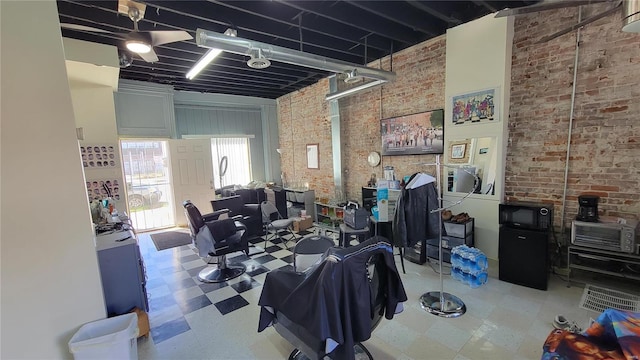 interior space with a towering ceiling and brick wall