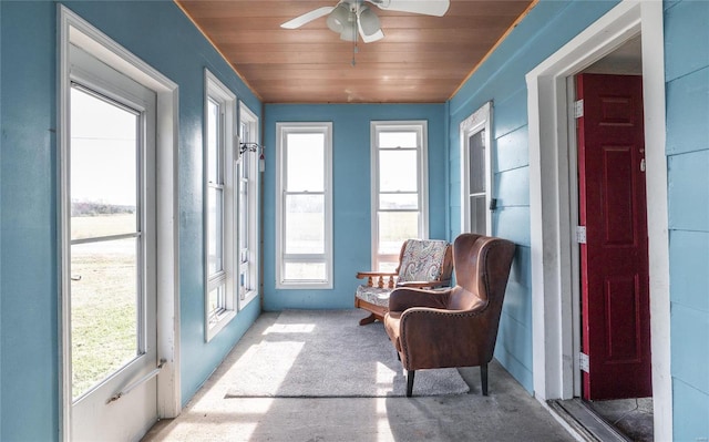 sunroom / solarium featuring wooden ceiling and ceiling fan