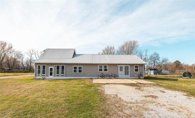 view of front of house with a patio and a front lawn