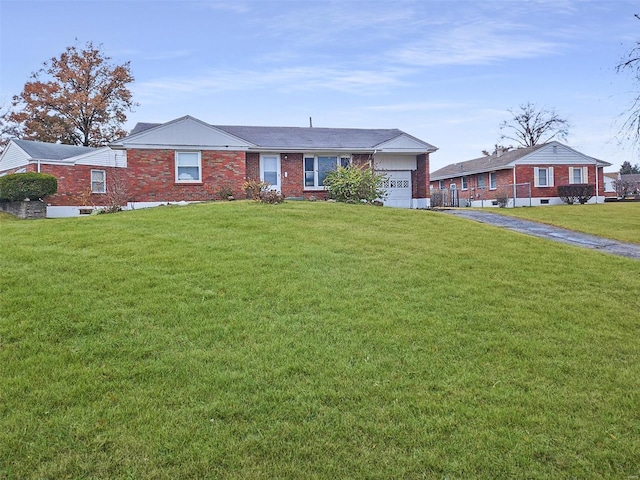 single story home featuring a garage and a front yard