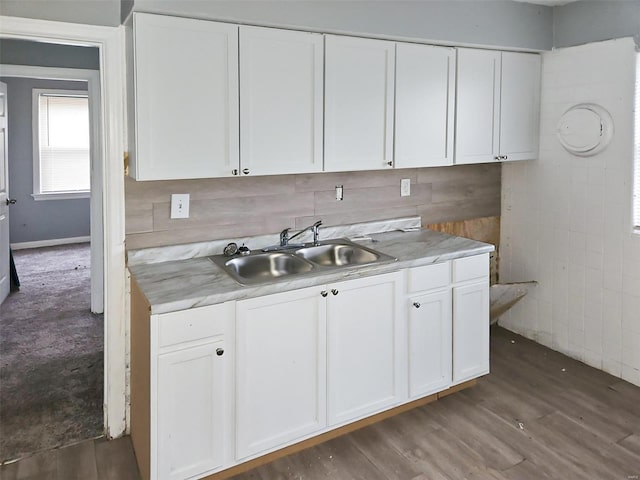 kitchen with tile walls, sink, white cabinets, and dark hardwood / wood-style floors