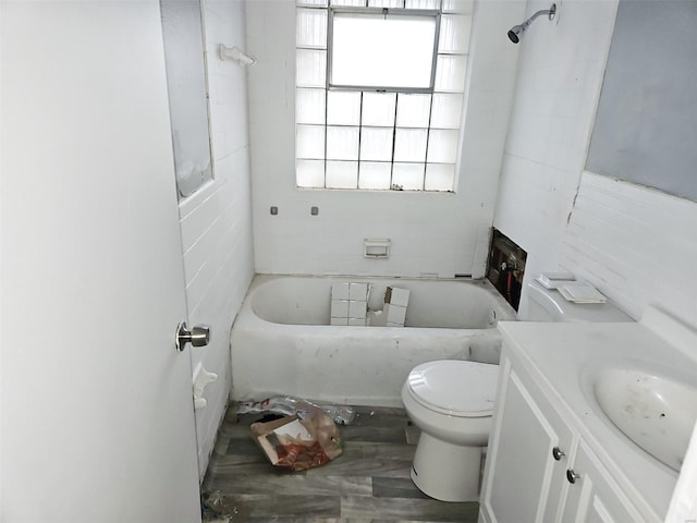 bathroom featuring vanity, toilet, and tile walls