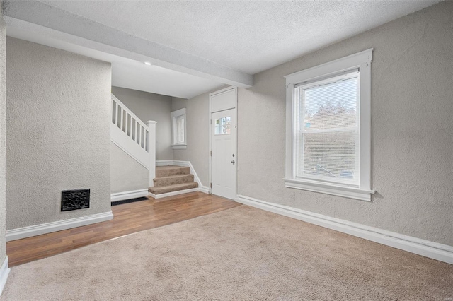 entrance foyer with wood-type flooring and a textured ceiling