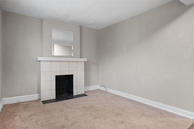 unfurnished living room featuring a textured ceiling, a fireplace, and light carpet