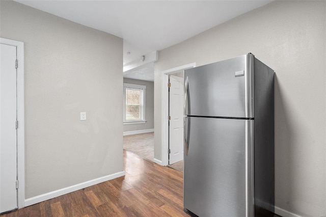 kitchen featuring stainless steel refrigerator and dark hardwood / wood-style floors