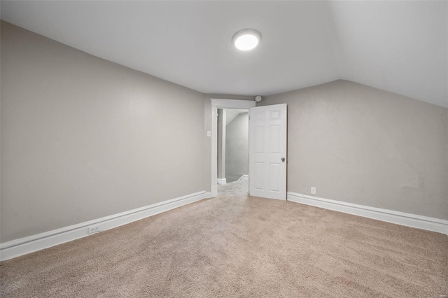 additional living space with carpet and lofted ceiling