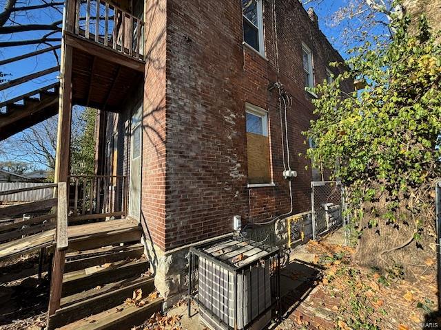 view of home's exterior with a balcony and central AC unit