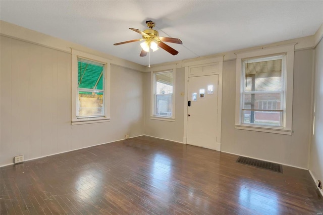 foyer entrance with ceiling fan and dark hardwood / wood-style flooring