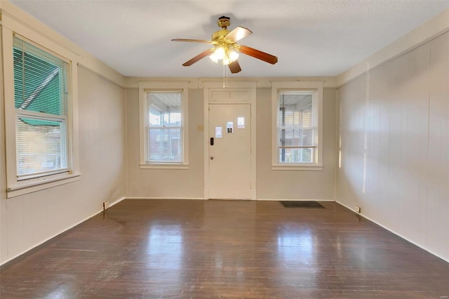 entrance foyer with plenty of natural light, dark hardwood / wood-style floors, a textured ceiling, and ceiling fan