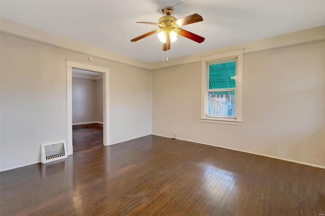 spare room with ceiling fan and dark hardwood / wood-style floors