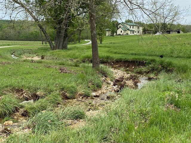 view of yard with a rural view