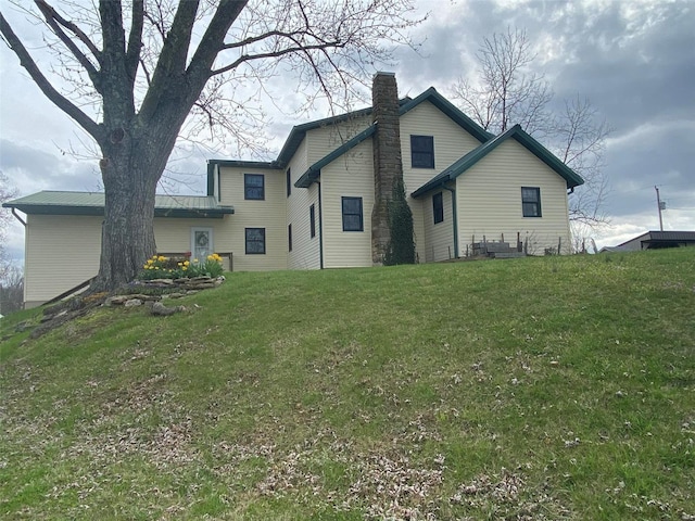 rear view of house with a lawn