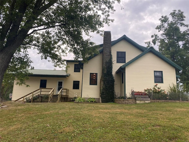 rear view of property with a yard