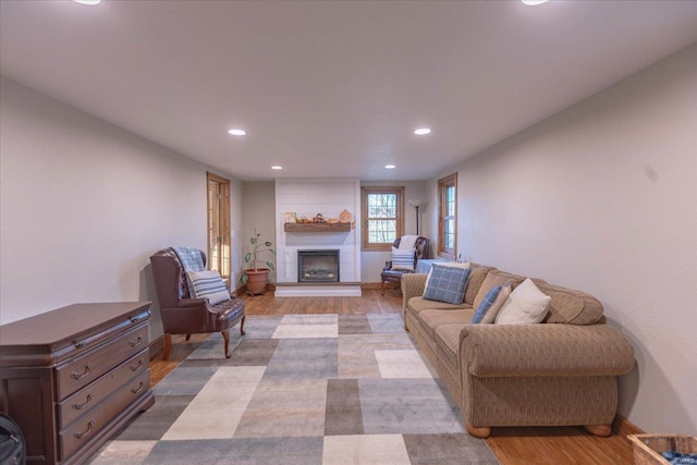 living room with light wood-type flooring and a fireplace