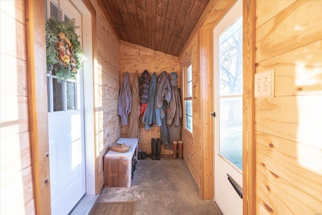 mudroom with wood ceiling, vaulted ceiling, and wood walls