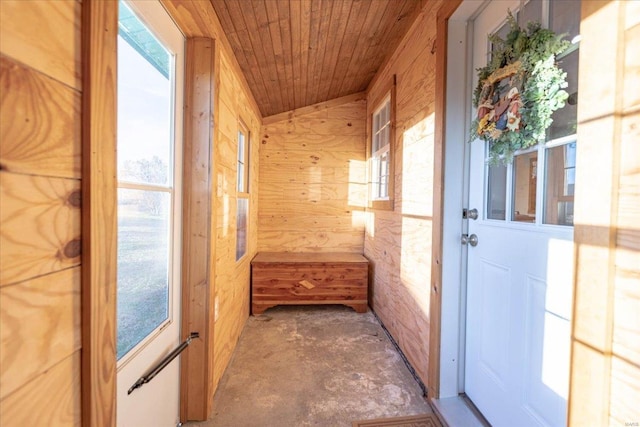 corridor featuring wood ceiling and wooden walls