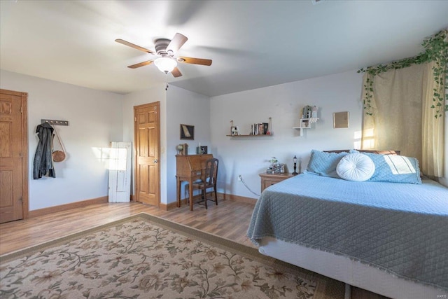 bedroom with ceiling fan and hardwood / wood-style floors