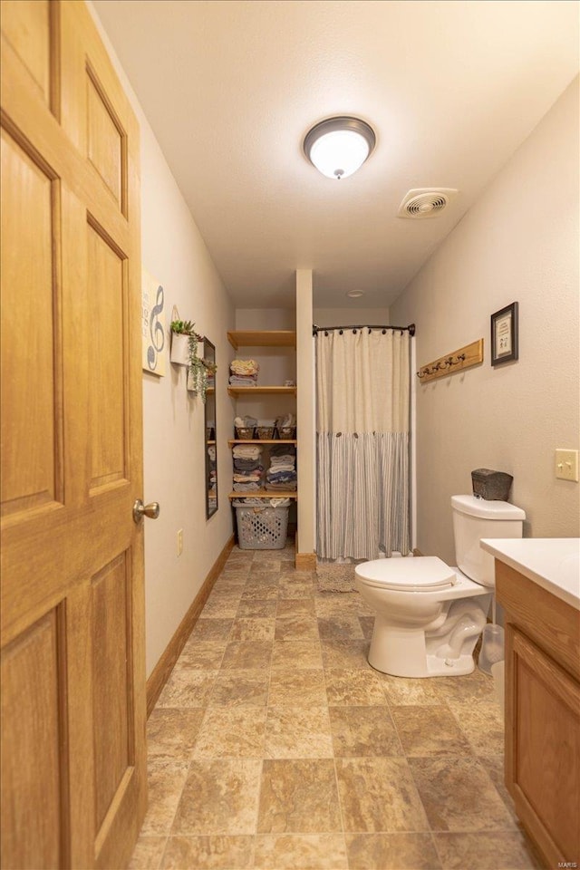 bathroom featuring toilet and vanity