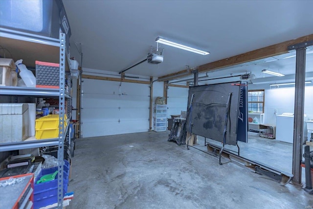 garage with a garage door opener and washer / clothes dryer