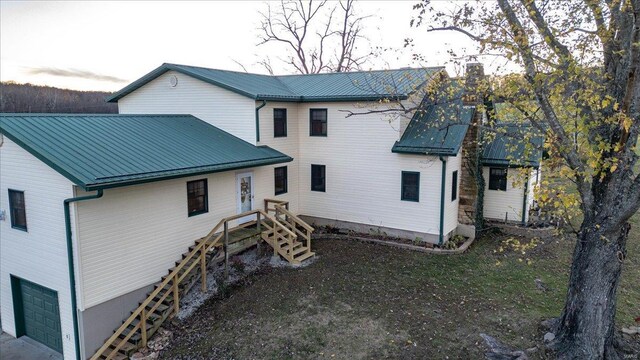 rear view of house with a garage