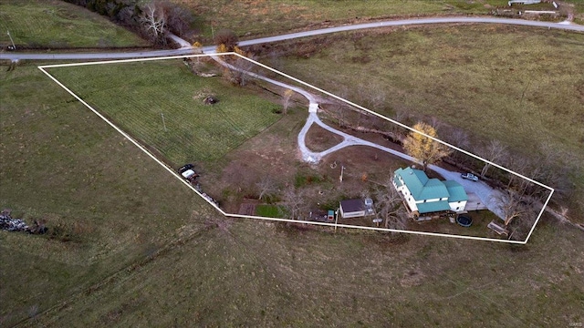 birds eye view of property with a rural view