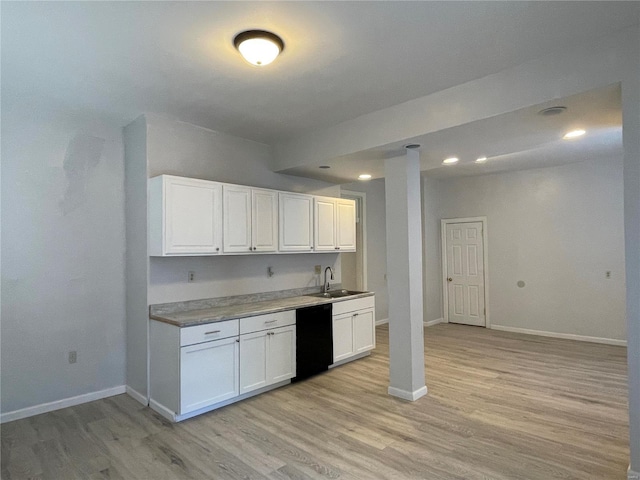 kitchen with white cabinets, black dishwasher, light hardwood / wood-style flooring, and sink