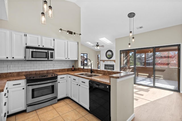 kitchen with decorative light fixtures, sink, white cabinetry, and stainless steel appliances