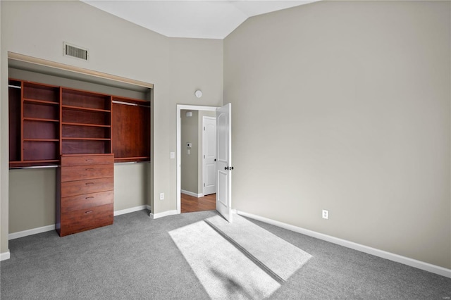 unfurnished bedroom featuring carpet and lofted ceiling