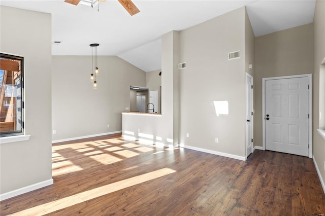 interior space with dark hardwood / wood-style flooring, vaulted ceiling, and ceiling fan