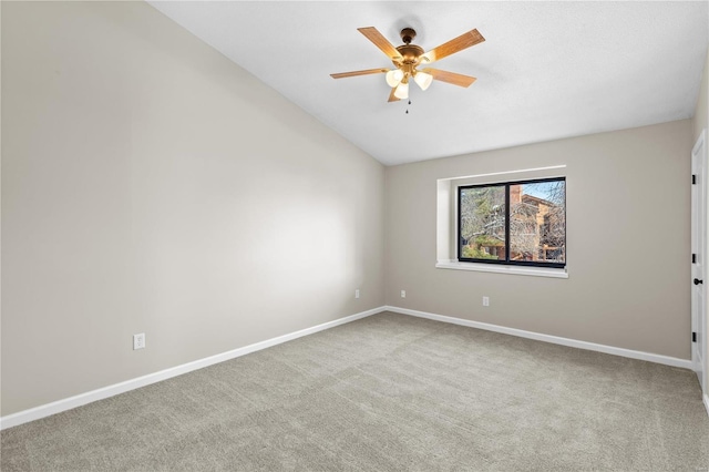 spare room featuring vaulted ceiling, ceiling fan, and carpet flooring