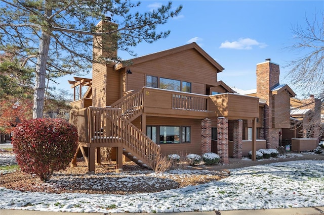 snow covered property with a balcony