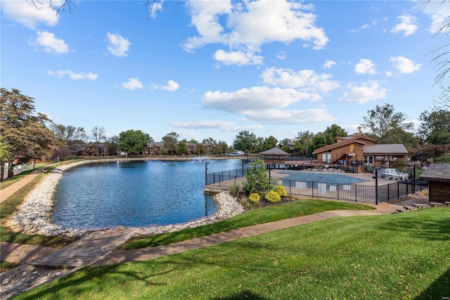 view of pool featuring a water view and a lawn