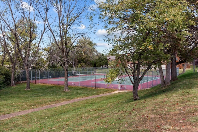 view of sport court with a lawn