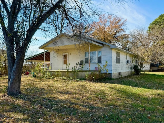 view of side of property with a lawn