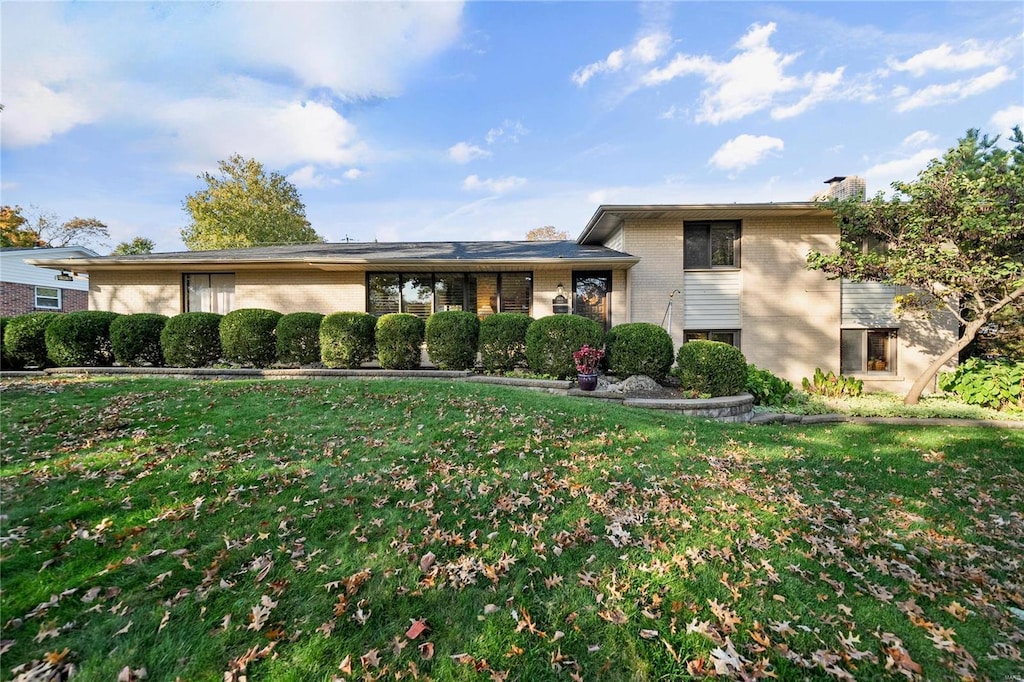 split level home featuring a front lawn