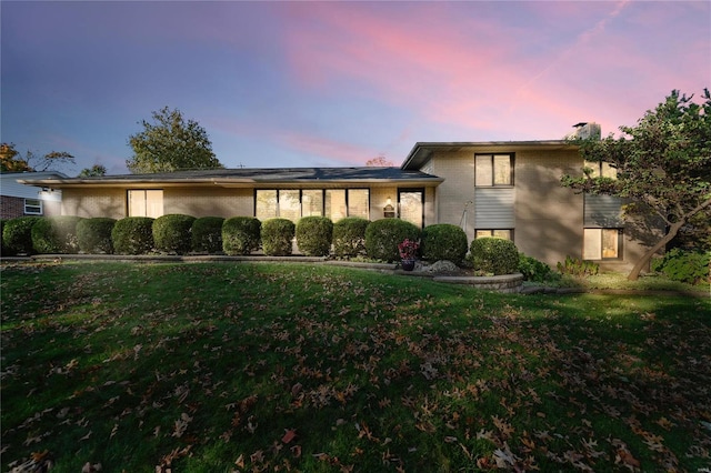 split level home featuring a yard