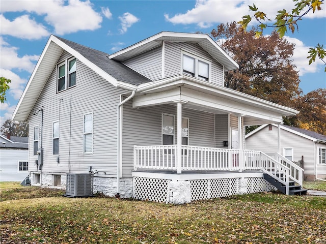 view of front facade with central air condition unit, a front lawn, and a porch