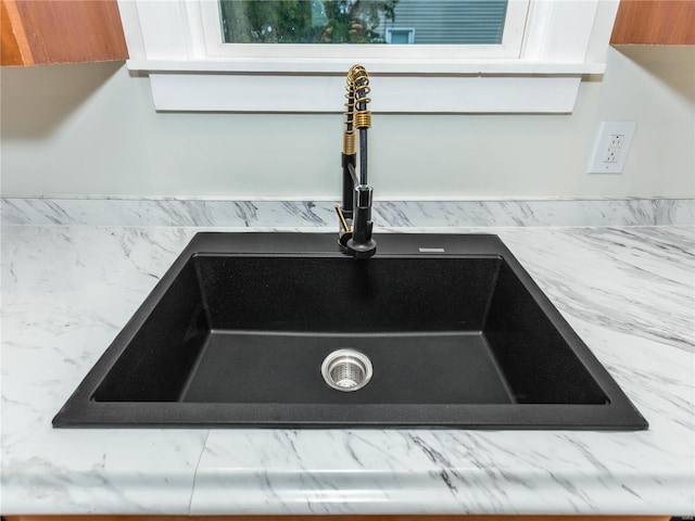 interior details featuring white cabinetry and sink