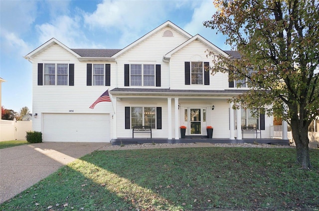 view of front of house with covered porch, a garage, and a front lawn