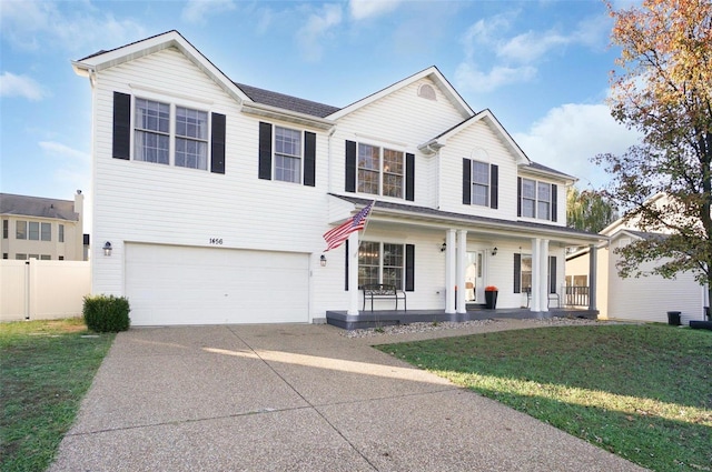 view of front of home featuring a front lawn, a porch, and a garage