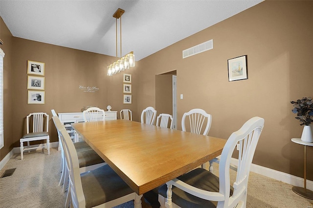 dining room featuring a notable chandelier and carpet floors