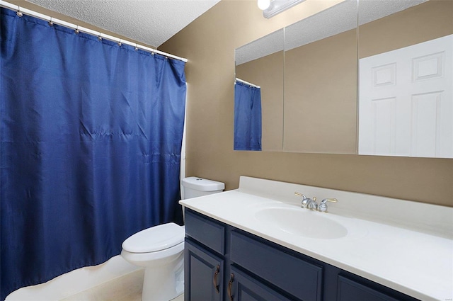 bathroom featuring vanity, toilet, and a textured ceiling