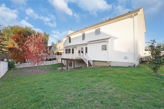 back of house featuring a lawn