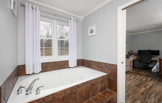 bathroom with tiled bath, crown molding, and hardwood / wood-style flooring