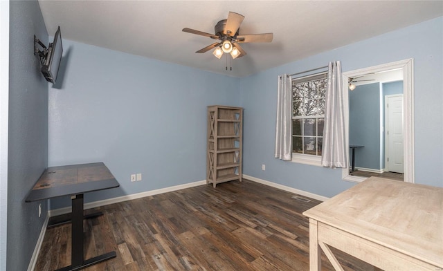 miscellaneous room with ceiling fan and dark wood-type flooring