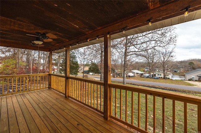 wooden terrace with a yard and ceiling fan