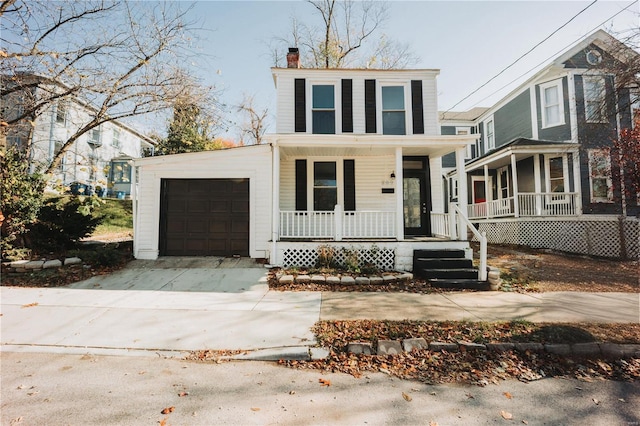 view of front property with covered porch and a garage