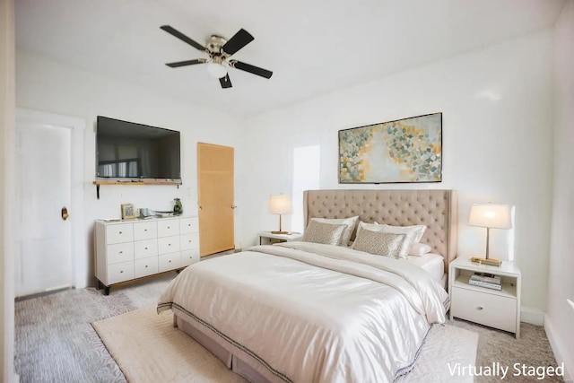 bedroom featuring ceiling fan and light carpet