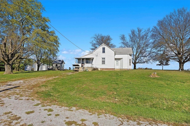 view of side of home with a yard