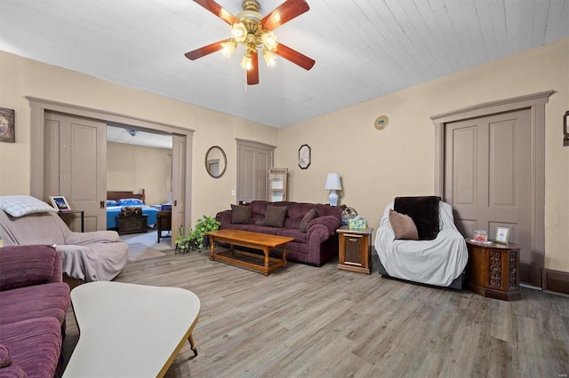 living room with ceiling fan and light hardwood / wood-style floors